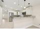 Modern kitchen with stainless steel appliances, granite countertops, and breakfast bar at 212 W Humphrey St, Tampa, FL 33604