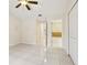 Primary bedroom with tile floors leads to bathroom with walk-in shower at 212 W Humphrey St, Tampa, FL 33604