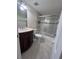 Bathroom features a marble vanity, decorative tiling, and shower/tub combo with sliding glass doors at 226 Thorn Tree Pl # 226, Brandon, FL 33510