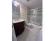 A traditional bathroom with vanity and sliding glass doors to tub at 226 Thorn Tree Pl # 226, Brandon, FL 33510