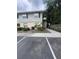 Two-story apartment building with light blue siding and beige accents, surrounded by green bushes and a concrete walkway at 226 Thorn Tree Pl # 226, Brandon, FL 33510