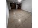 Neutral living room with tile flooring, ceiling fan, and view to the kitchen at 226 Thorn Tree Pl # 226, Brandon, FL 33510