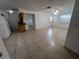 Open living room with tile flooring, ceiling fan, and a view into the kitchen at 226 Thorn Tree Pl # 226, Brandon, FL 33510