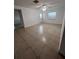 Bright living room featuring neutral tile, a ceiling fan, and natural light from a window and door at 226 Thorn Tree Pl # 226, Brandon, FL 33510