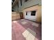 Private outdoor patio with red and beige patterned tile and a small back door at 226 Thorn Tree Pl # 226, Brandon, FL 33510