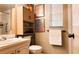 Bright bathroom with modern fixtures, storage cabinet, and decorative art at 230 N Bayshore Blvd # 103, Clearwater, FL 33759