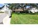 Well-maintained exterior with lush green lawn and mature landscaping at 230 N Bayshore Blvd # 103, Clearwater, FL 33759