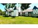 Unique Tudor-style condo with black and white details, complemented by a lush green lawn and mature trees at 230 N Bayshore Blvd # 103, Clearwater, FL 33759
