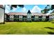 Charming Tudor-style condo building with well-maintained lawn and intricate black and white facade details at 230 N Bayshore Blvd # 103, Clearwater, FL 33759