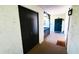 Inviting condo hallway featuring a large closet and decorative door leading to unit 102 at 230 N Bayshore Blvd # 103, Clearwater, FL 33759