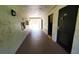 Inviting hallway with textured walls leads to bright, open spaces at 230 N Bayshore Blvd # 103, Clearwater, FL 33759