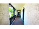Well-lit condo hallway with textured walls and decorative railings, leading to unit entrances at 230 N Bayshore Blvd # 103, Clearwater, FL 33759
