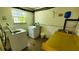 Functional laundry room with modern washer, dryer, and convenient folding table at 230 N Bayshore Blvd # 103, Clearwater, FL 33759