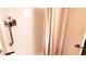 Clean shower equipped with a shower curtain, shower caddy and metal safety bar at 230 N Bayshore Blvd # 103, Clearwater, FL 33759