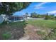 Sprawling backyard with partial fence, picnic table, and back of the house with screened in porch at 2419 Wishing Well Way, Tampa, FL 33619