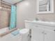 Bathroom featuring a tiled shower, toilet, and vanity with ample cabinet space at 2419 Wishing Well Way, Tampa, FL 33619