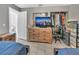 Nicely appointed bedroom with wood dresser, TV, and a glimpse into the bathroom at 2419 Wishing Well Way, Tampa, FL 33619