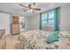 Bedroom with a view into a walk-in closet and features a ceiling fan and tile flooring at 2419 Wishing Well Way, Tampa, FL 33619
