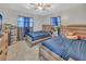 Shared bedroom showcasing two beds with matching headboards and a ceiling fan at 2419 Wishing Well Way, Tampa, FL 33619