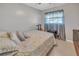 Bedroom with a patterned comforter, ceiling fan, and tile flooring at 2419 Wishing Well Way, Tampa, FL 33619