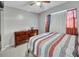 Relaxing bedroom with dresser and natural light at 2419 Wishing Well Way, Tampa, FL 33619