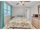 Bedroom with tile flooring, bright window, ceiling fan, and light-colored walls at 2419 Wishing Well Way, Tampa, FL 33619