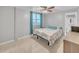 Comfortable bedroom with a ceiling fan, bright window, and tile flooring at 2419 Wishing Well Way, Tampa, FL 33619