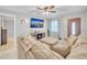 Cozy living room featuring a large sofa, ceiling fan, and mounted TV at 2419 Wishing Well Way, Tampa, FL 33619
