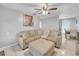 Comfortable living room featuring a plush sectional sofa and a decorative Buddha artwork at 2419 Wishing Well Way, Tampa, FL 33619
