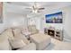 Comfortable living room with neutral tones, a ceiling fan, and a view of a television and electric fireplace at 2419 Wishing Well Way, Tampa, FL 33619
