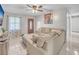 Comfortable living room featuring a plush sectional sofa and a decorative Buddha artwork at 2419 Wishing Well Way, Tampa, FL 33619