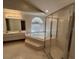 Bright bathroom features a step-up jacuzzi tub, walk-in shower with glass door, and dual sink vanity at 2635 Jarvis Cir, Palm Harbor, FL 34683
