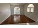 Inviting dining space with hardwood floors, arched windows, and elegant chandelier at 2635 Jarvis Cir, Palm Harbor, FL 34683