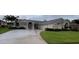 Well-maintained home with a spacious driveway and charming landscaping, perfect for welcoming guests at 2635 Jarvis Cir, Palm Harbor, FL 34683