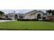 Lovely single-story home with a well-manicured lawn, swaying palm trees, and beautiful landscaping at 2635 Jarvis Cir, Palm Harbor, FL 34683