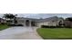 Stunning single-story home featuring a spacious driveway and meticulously maintained front yard at 2635 Jarvis Cir, Palm Harbor, FL 34683
