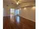 Spacious living room featuring hardwood floors, a ceiling fan, recessed lights, and an entry to the main bathroom at 2635 Jarvis Cir, Palm Harbor, FL 34683