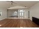 Open living area with wood flooring, arched windows, and entry to bathroom area at 2635 Jarvis Cir, Palm Harbor, FL 34683