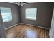 Comfortable bedroom with wood floors, neutral walls, and natural light from windows at 2910 15Th Ave S, St Petersburg, FL 33712