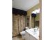 Well-lit bathroom featuring a patterned shower curtain and a white vanity at 29435 Snap Hook Dr, San Antonio, FL 33576