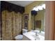 Well-lit bathroom featuring a patterned shower curtain and a white vanity at 29435 Snap Hook Dr, San Antonio, FL 33576