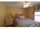 Cozy bedroom with a decorative bed frame, hardwood floors, and a ceiling fan at 29435 Snap Hook Dr, San Antonio, FL 33576