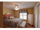 Cozy bedroom with a decorative bed frame, hardwood floors, and a ceiling fan at 29435 Snap Hook Dr, San Antonio, FL 33576