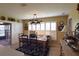 Charming dining area with a wooden table, shutters, and decor plates; leads to enclosed outdoor space at 29435 Snap Hook Dr, San Antonio, FL 33576