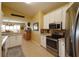 Bright kitchen featuring white cabinets, stainless steel appliances, and a view into the adjacent dining area at 29435 Snap Hook Dr, San Antonio, FL 33576