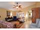 Inviting living room with stylish furnishings, a ceiling fan, and ample natural light through shuttered windows at 29435 Snap Hook Dr, San Antonio, FL 33576
