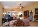 Cozy living room featuring tile flooring, shuttered windows, and a ceiling fan at 29435 Snap Hook Dr, San Antonio, FL 33576
