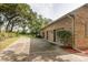 Spacious three-car garage with a long driveway, nestled beside a beautifully landscaped yard with mature trees at 3042 Oak Creek N Dr, Clearwater, FL 33761
