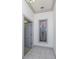 Hallway with tile flooring, gray trim, and decorative stained-glass window at 3042 Oak Creek N Dr, Clearwater, FL 33761