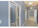 Hallway with carpet, mirrored closet doors, and white trim at 3042 Oak Creek N Dr, Clearwater, FL 33761